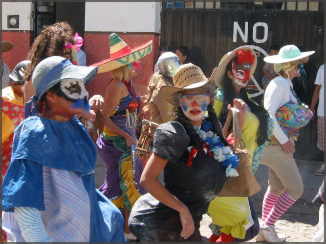 Group of partyers with different mask in the carnival parade.