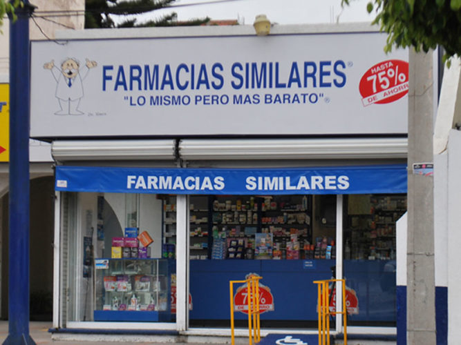 white and blue farmacia similares sign above store entrance with counter and stocked shelves inside