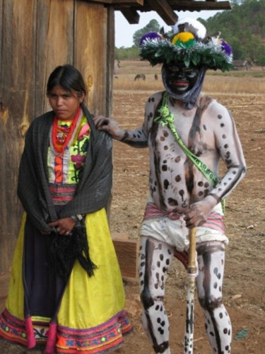 Traditionally dressed Huichol woman and man with totally painted body symbolizing the rich Ajijic history.