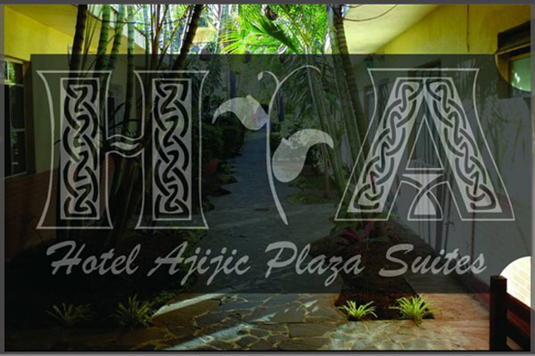 Logo and side garden area of Plaza Suites hotel.