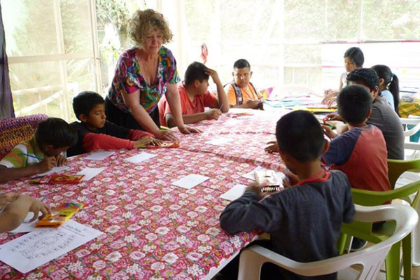 Children of San Juan Cosala learning English by a volunteer of Operation Feed.