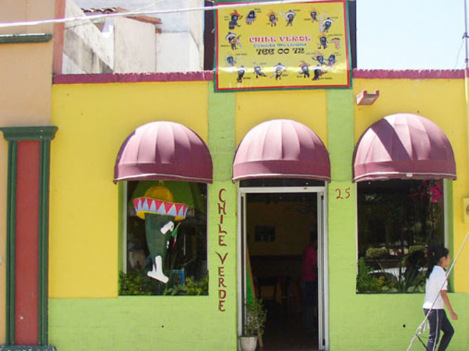 Downtown Ajijic Restaurant Chili Verder view from the street with purple awnings and yellow and green painted walls.