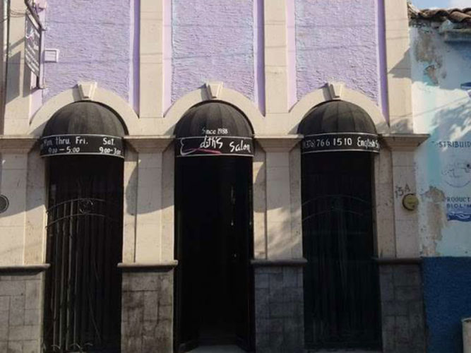 Edith's Salon street view with purple walls 3 arched windows with black awnings