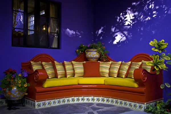 Outdoor seating area with red sofa and pillows at Estrellitas Bed and Breakfast in Ajijic.