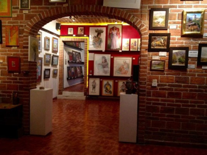 Framed art hanging on walls in two rooms at Studio 18 in Ajijic, Mexico.