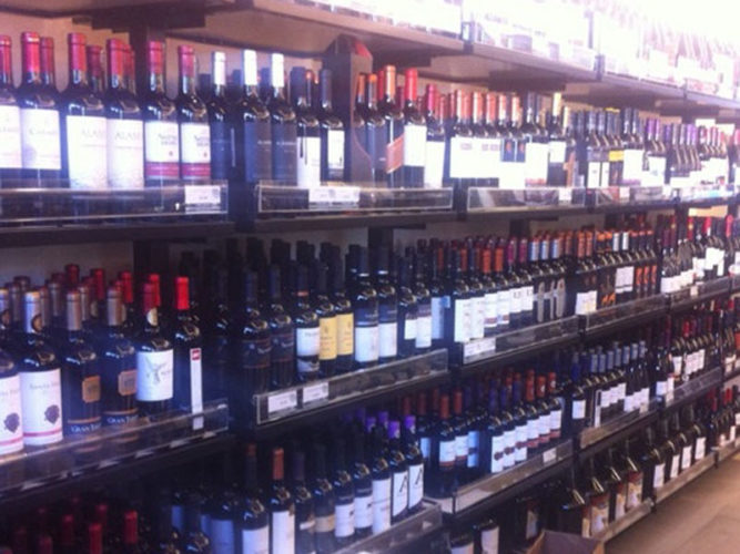 Four rows of wine stacked shelves in Vino America in Ajijic, Mexico.