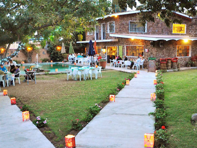 Candle lined walkways leading through the garden at Yves Restaurant in Ajijic.